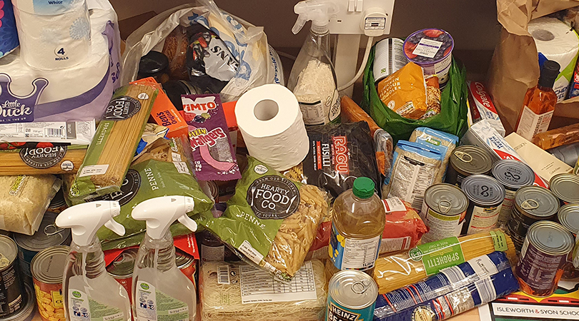 A collection of food items arranged on a desk.