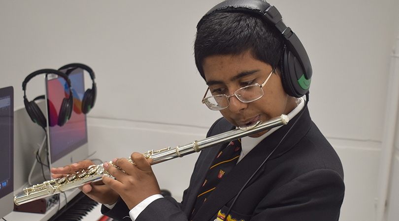 A student plays a flute.