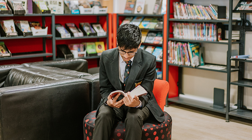 A student reads in the library.