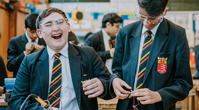 Two students laugh during a DT lesson.