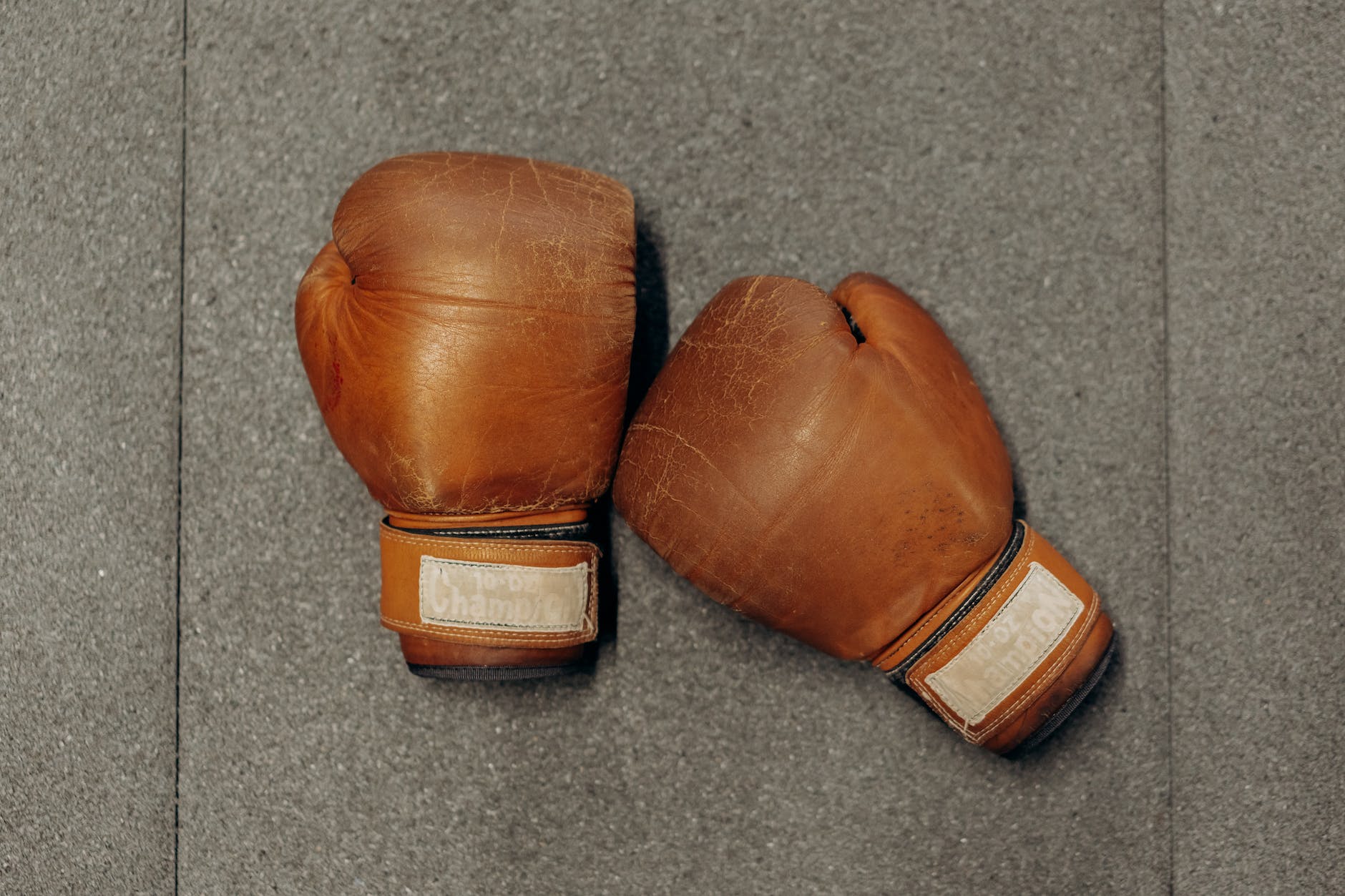 pair of boxing gloves on gray surface